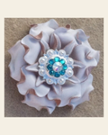 White Gardenia Flower With Bright Silver Teal and AB 1" Concho on a warm cream background