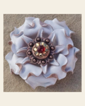 White Gardenia Flower With Copper Ruby and Champagne 1" Concho on a warm cream background