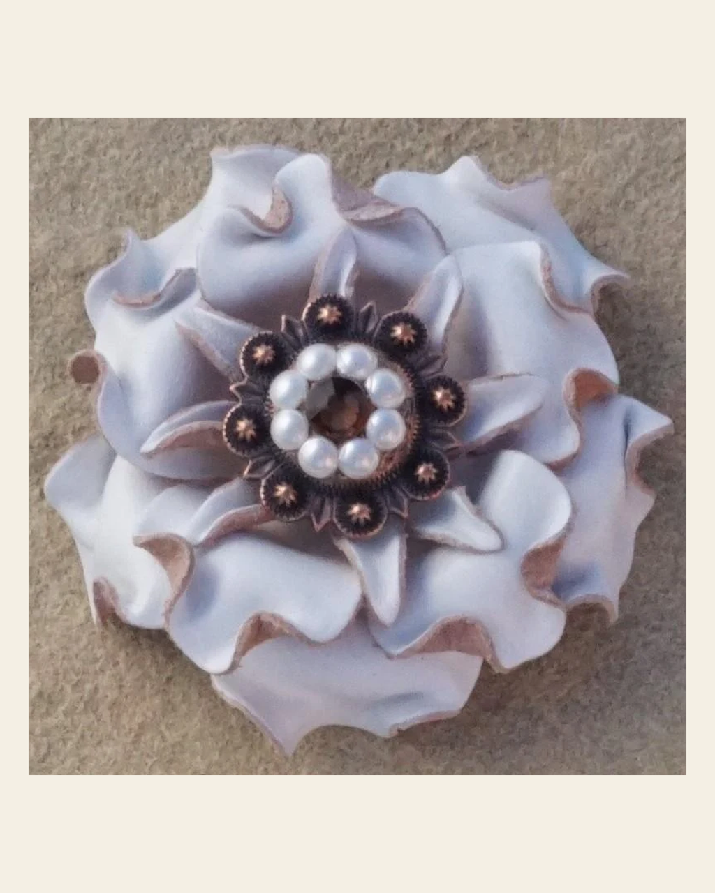 White Gardenia Flower With Copper Topaz & Pearl 1" Concho on a warm cream background