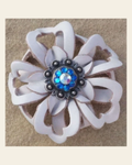 White Lotus Flower With Antique Silver Capri and AB 1" Concho on a warm cream background