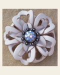 White Lotus Flower With Antique Silver Light Sapphire and AB 1" Concho on a warm cream background