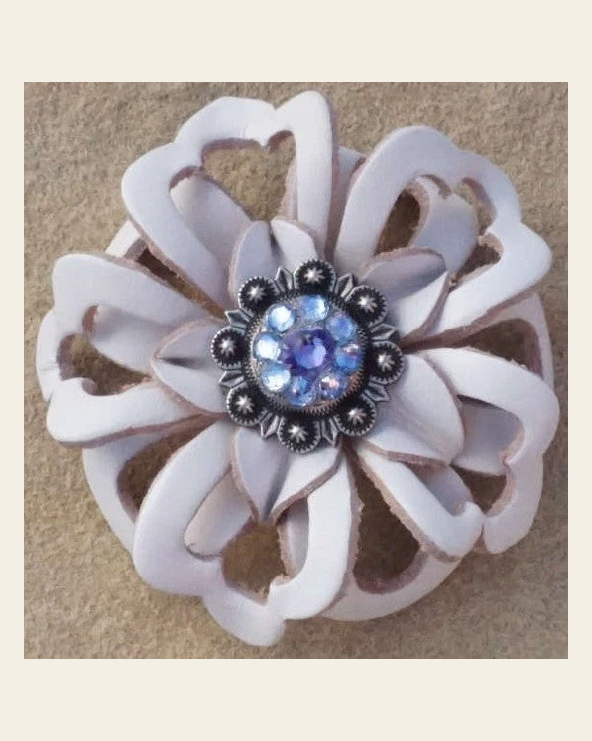 White Lotus Flower With Antique Silver Lilac and Light Sapphire 1" Concho on a warm cream background