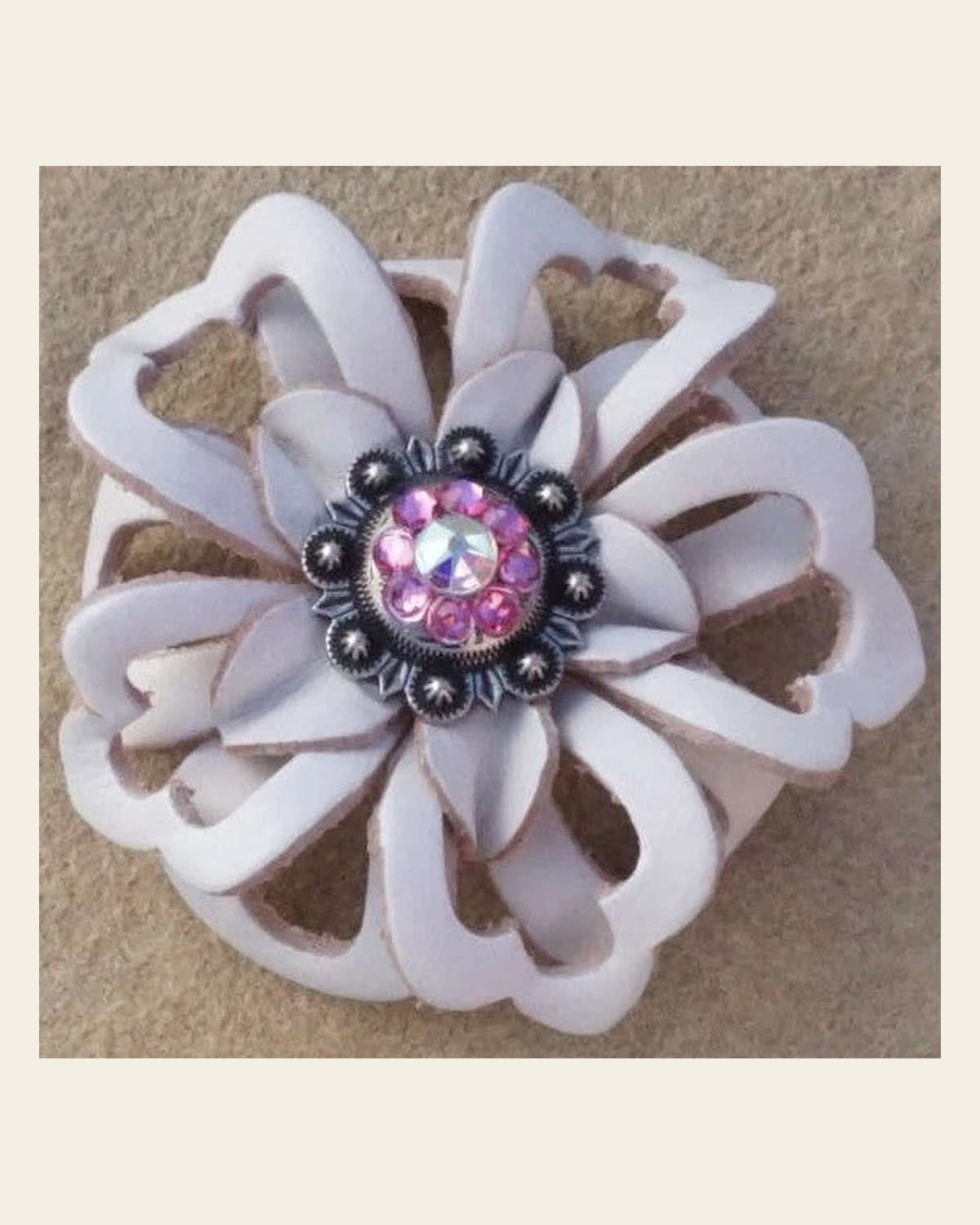 White Lotus Flower With Antique Silver Pink and AB 1" Concho on a warm cream background