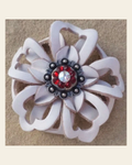White Lotus Flower With Antique Silver Ruby and AB 1" Concho on a warm cream background