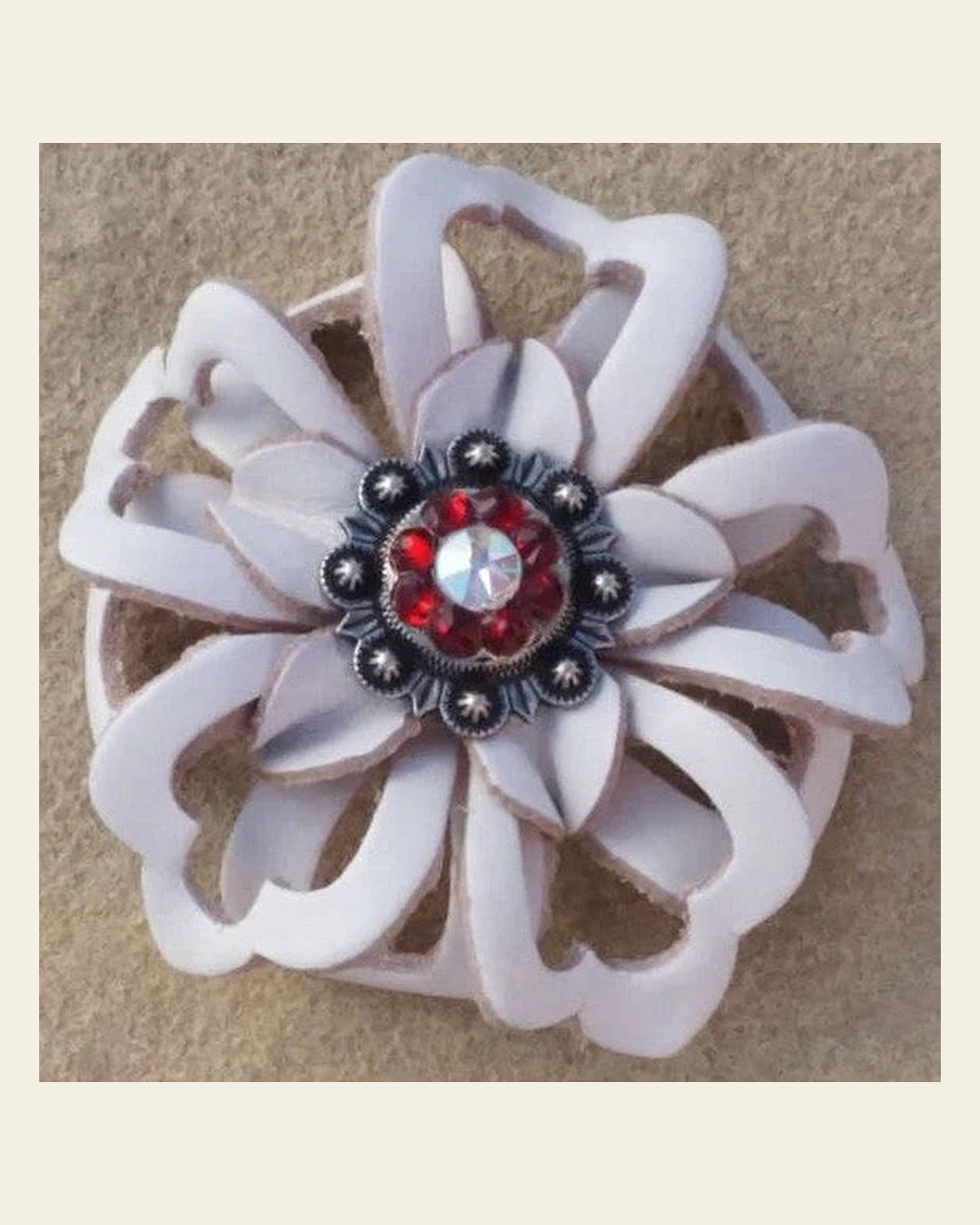 White Lotus Flower With Antique Silver Ruby and AB 1" Concho on a warm cream background