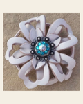 White Lotus Flower With Antique Silver Teal & AB 1" Concho on a warm cream background