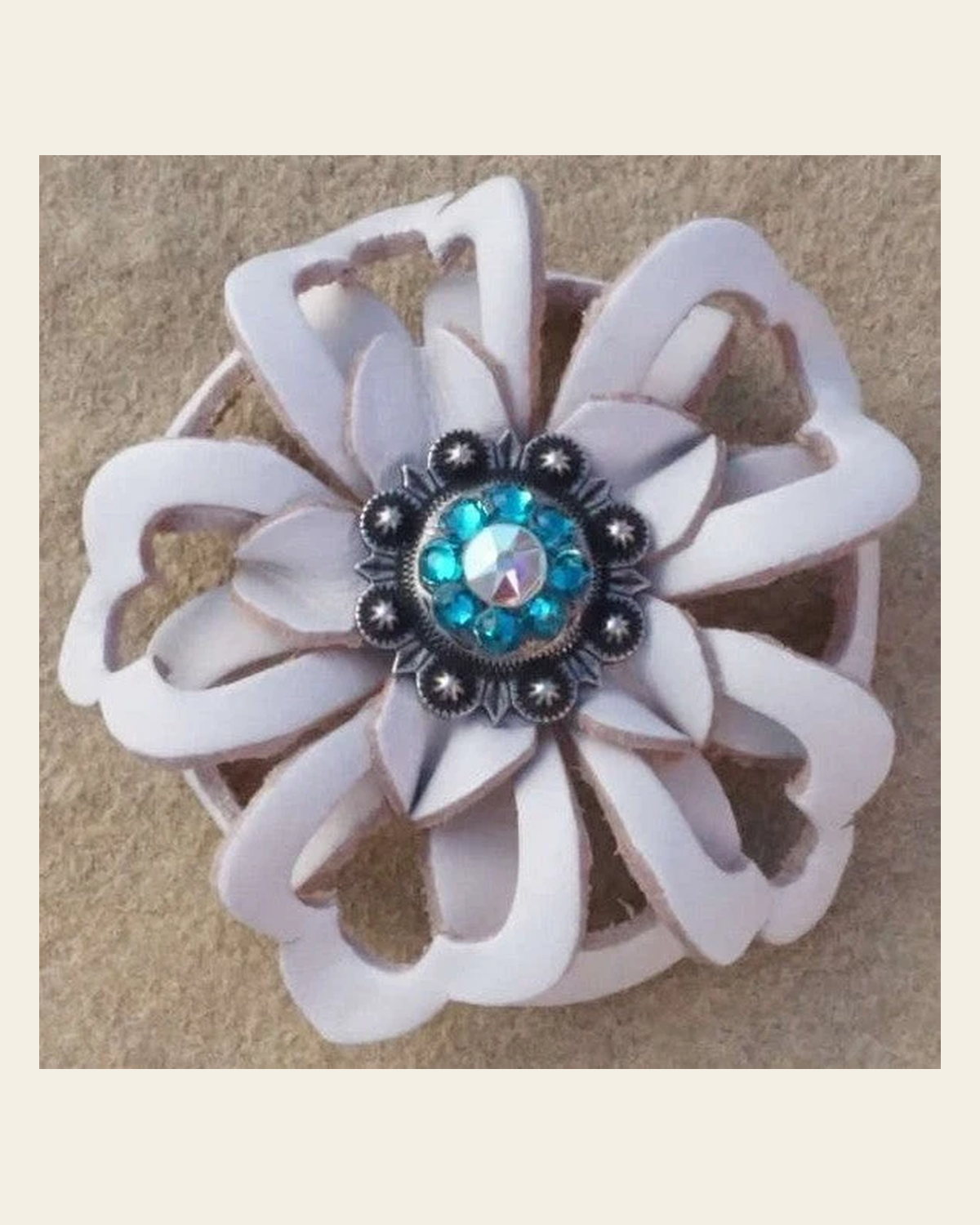 White Lotus Flower With Antique Silver Teal & AB 1" Concho on a warm cream background