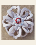 White Lotus Flower With Bright Silver Ruby and AB 1" Concho on a warm cream background