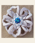 White Lotus Flower With Bright Silver Teal and Capri 1" Concho on a warm cream background