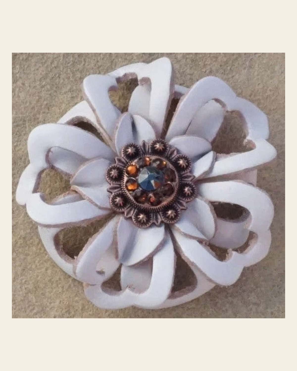 White Lotus Flower With Copper Jet and Topaz 1" Concho on a warm cream background