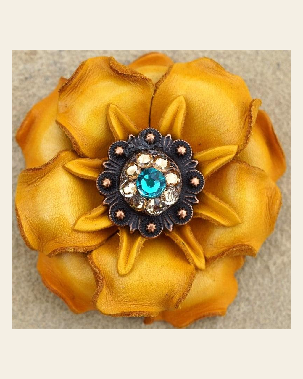 Yellow Gardenia Flower With Copper Teal & Champagne 1" Concho on a warm cream background