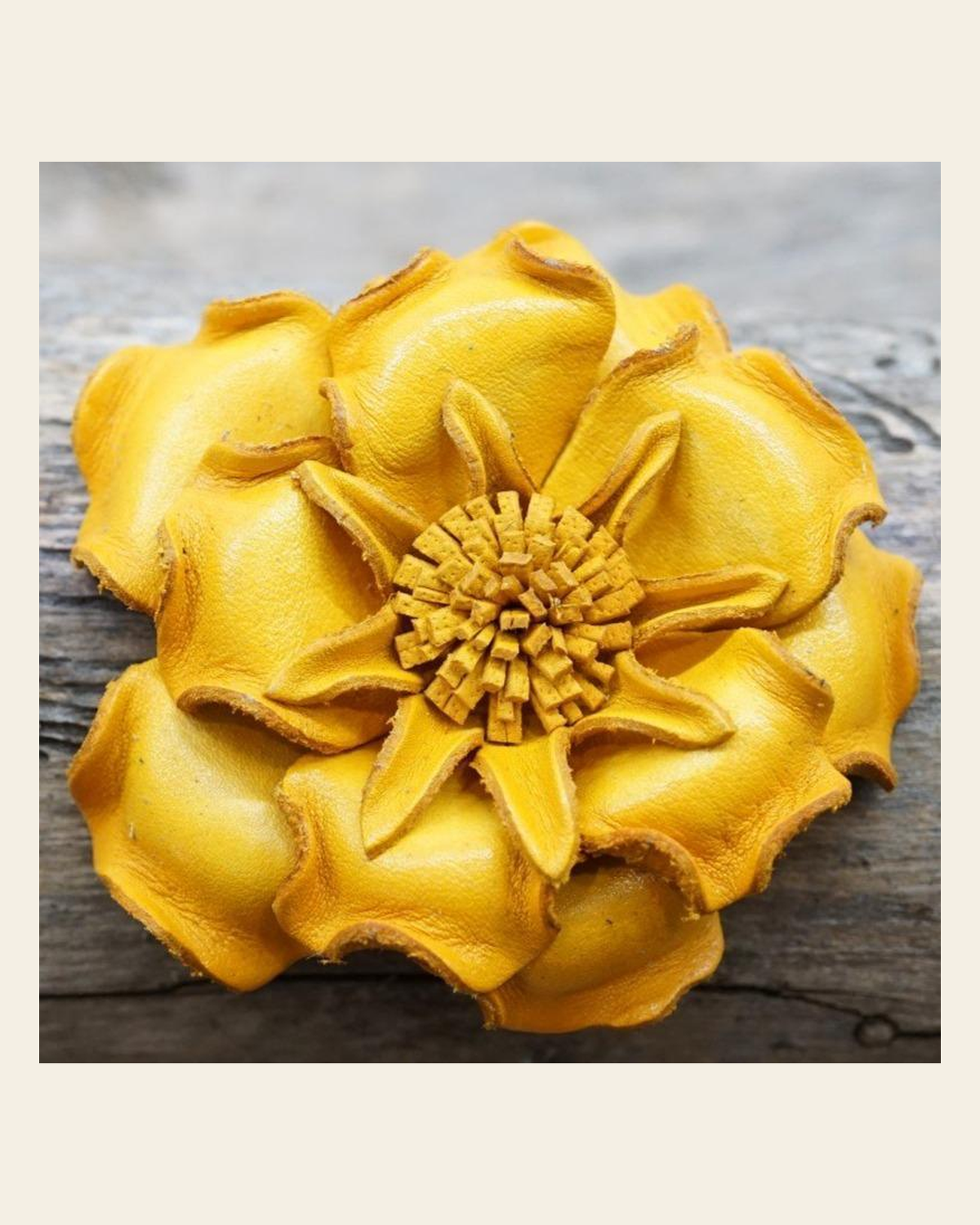 Yellow Gardenia Leather Flower on a warm cream background