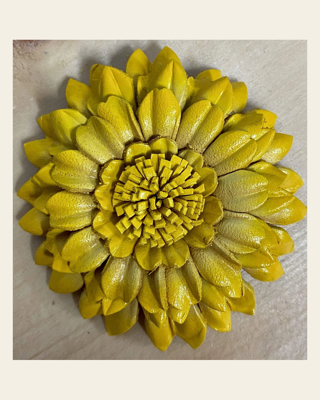 Yellow Sunflower Leather Flower on a warm cream background