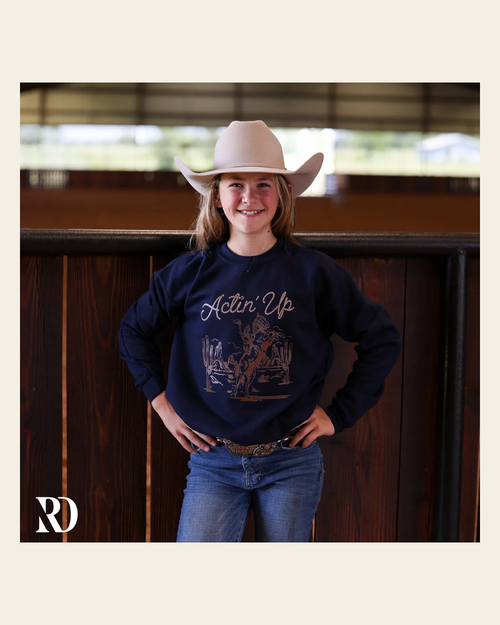 *youth* Actin' Up Cowgirl | Crewneck on a warm cream background