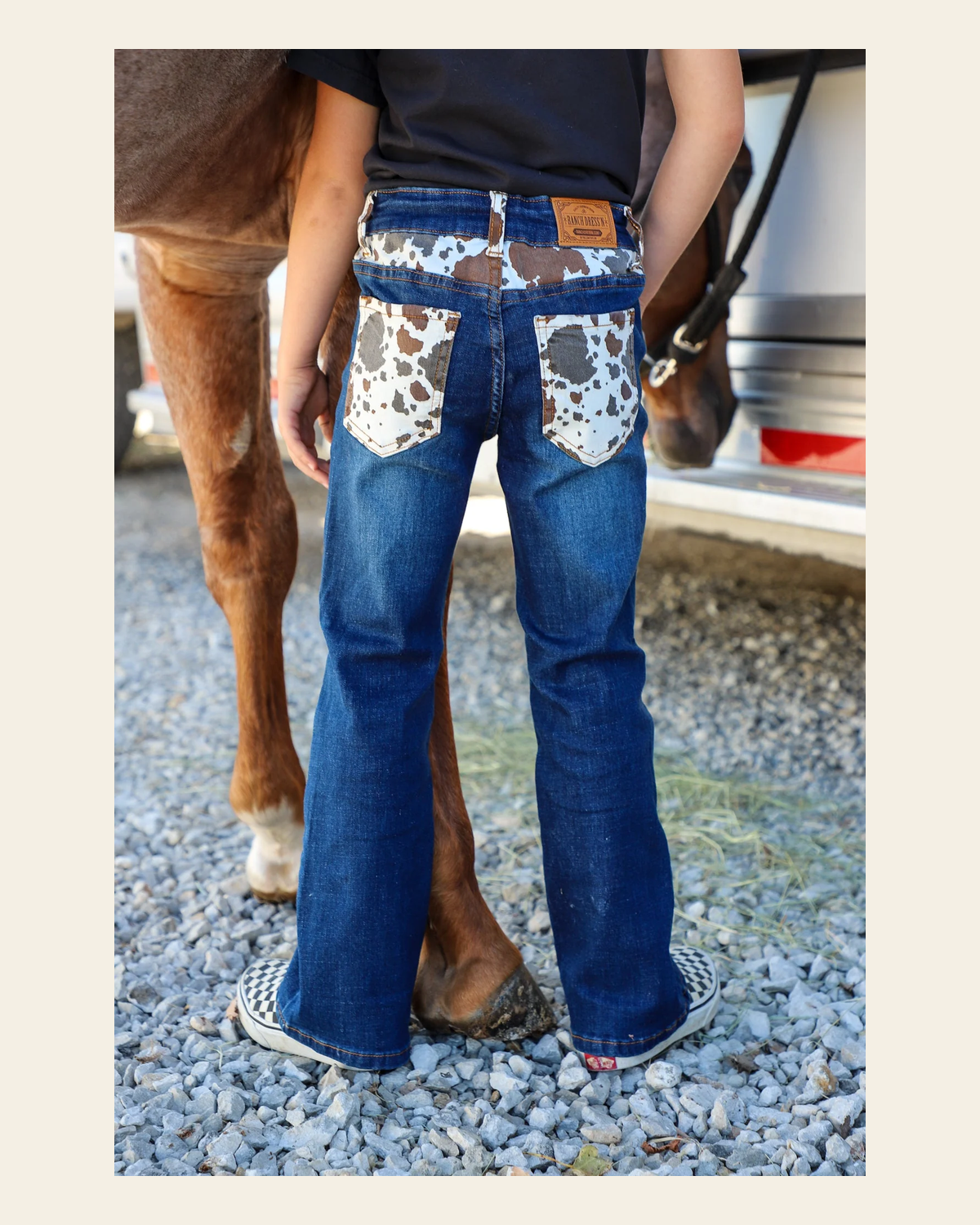 *youth* Cattle Drive Denim Bootcut Jeans on a warm cream background